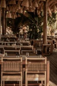 a dining room with tables and chairs in a restaurant at Kohylia by La Scala Beach in Limenas