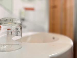 a bathroom sink with a glass jar on top of it at Hotel Rhein-Ruhr Bottrop in Bottrop