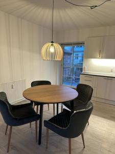 mesa de comedor con sillas y luz eólica en Højbanetorvet11, en Vejle