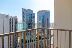 a balcony with a view of some tall buildings at Modern 1 Bedroom In Reflections in Abu Dhabi
