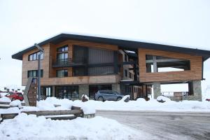 a large building with snow in front of it at ski-in/ski-out apartment in Gudauri in Gudauri