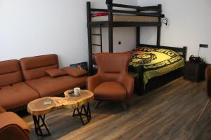 a living room with a couch and a bed at ski-in/ski-out apartment in Gudauri in Gudauri