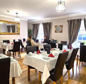 two women sitting at tables in a restaurant at Waterloo Lodge in Dublin