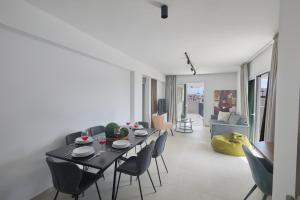 a living room with a black table and chairs at Eva Residences- Kapparis in Paralimni