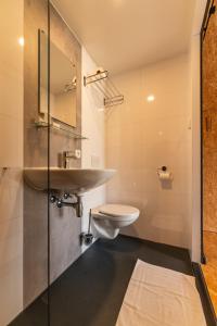 a bathroom with a sink and a toilet at Tenthuisje met hottub in Callantsoog in Callantsoog