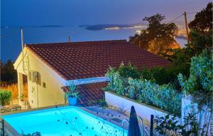 una piscina di fronte a una casa di Gorgeous Home In Podstrana With House Sea View a Podstrana