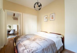 a bedroom with a large bed and a table at Borgo dalle Tovaglie in Bologna