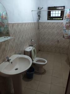 a bathroom with a sink and a toilet at 67 holiday home in Badulla