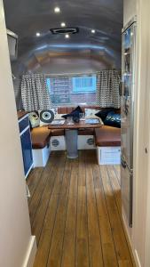 a kitchen with a desk in the middle of a rv at Airstream Experience in Knutsford