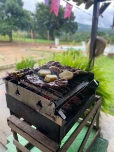 a grill with some food on top of it at Chácara Nascimento in Vitória de Santo Antão