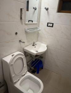a bathroom with a toilet and a sink at Gulnaar Inn in Chennai