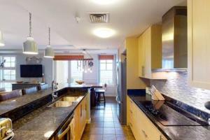 a large kitchen with a counter top and a dining room at Sojourn Penthouse Sanctuary Condo 4 BR in Virginia Beach +24 photos