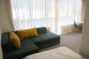 a living room with a couch in front of a window at ski-in/ski-out apartment in Bakuriani in Bakuriani