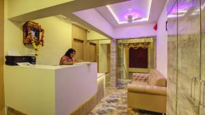 a woman sitting at a counter in a room at HOTEL SAPPHIRE INN in Thane