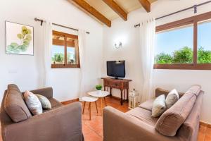 a living room with two couches and a tv at Sa Madoneta in Santanyi