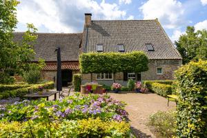 a garden in front of a house with flowers at Den Eijngel bed and breakfast in Boxtel