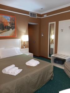 Postel nebo postele na pokoji v ubytování Cervara Park Hotel