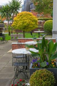 a group of tables and chairs with flowers and plants at Best Western New Kent Hotel in Newcastle upon Tyne