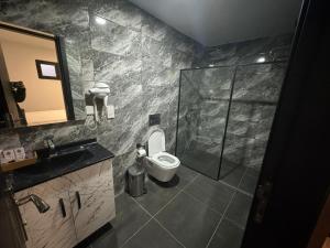 a bathroom with a shower and a toilet and a sink at Suya Boutique in Kyrenia