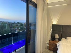 a bedroom with a bed and a view of a pool at Suya Boutique in Kyrenia