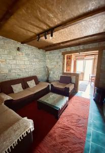 a living room with a couch and a table at Skadar Lake Apartment Nikola I in Virpazar