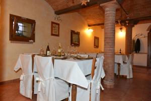 a dining room with a table with white table cloth at Agriturismo Calderino in Faenza