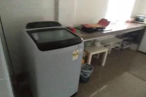 a small refrigerator in a room with a desk at Luxury Bungalow in Senawang in Seremban +5 photos