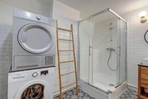 a washing machine in a bathroom with a shower at Louvre Montorgueuil Historical center 3BR II in Paris