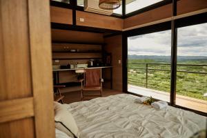 1 dormitorio con cama y ventana grande en Amazing mountain loft in La Cumbre en Los Cocos