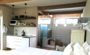 a bedroom with a bed and a small kitchen at Fresh in Cape Town