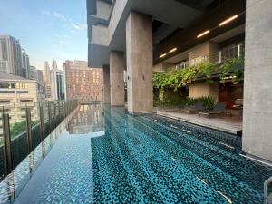 a swimming pool on the roof of a building at Anggun KL MY in Kuala Lumpur