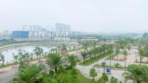 a view of a park with a river and buildings at Green Line Long Bien - Serviced Apartment - Ngoc Thuy - Hanoi in Hanoi