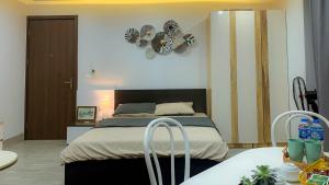 a bedroom with a bed and a clock on the wall at Green Line Long Bien - Serviced Apartment - Ngoc Thuy - Hanoi in Hanoi