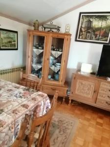 a bedroom with a wooden cabinet and a television at Apartment Relax in Zrenjanin
