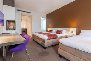 Postel nebo postele na pokoji v ubytování Hotel Lumen Zwolle