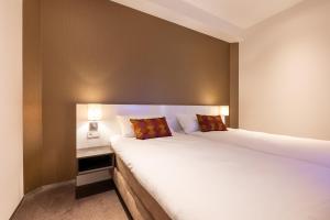 Postel nebo postele na pokoji v ubytování Hotel Lumen Zwolle