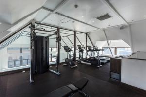 a gym with treadmills and ellipticals in a building at Courtyard by Marriott Puerto Montt in Puerto Montt