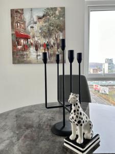 a statue of a dalmatian sitting on a table at Central Belfast Apartments Sandford in Belfast