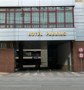ajar entrance to a building with a hotel parking at Hotel Tatra in Bratislava