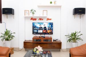 a living room with a flat screen tv on a wall at Villa 28C - Hồ Bơi Vũng Tàu Gần Biển Free Karaoke - Bida in Vung Tau