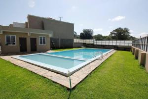 a large swimming pool in the backyard of a house at Lux Suites Milimani Executive Apartments in Nakuru