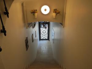a stairway with a window and flowers on the wall at Emin Cami Sokak No13 in Istanbul