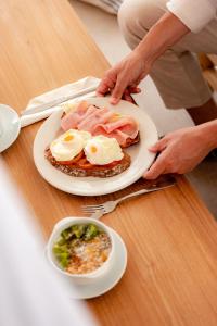 a plate of food with eggs and ham on a table at tent Lloret de Mar in Lloret de Mar