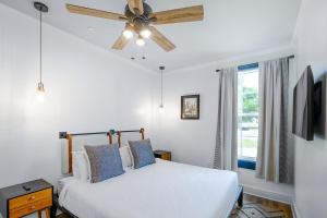 a bedroom with a bed and a ceiling fan at Old Spanish House- B, The Carter Jack Suite in Biloxi