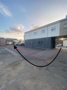 a black hose in a parking lot next to a building at Lumineux Apt 1BR Type Loft Proche Centre in Thionville