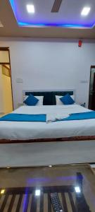 a bedroom with a bed with a remote control on it at The Kashi Inn - Near Assighat in Upal