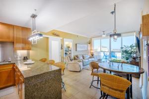 a kitchen and living room with a table and chairs at Ocean Club 406 in Biloxi
