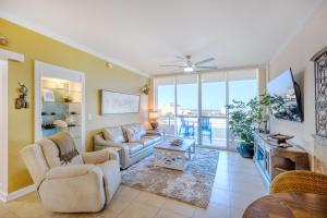 a living room with a couch and a table at Ocean Club 406 in Biloxi
