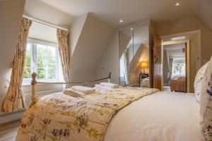 a bedroom with a large bed and a large mirror at York Cottage in Thornham