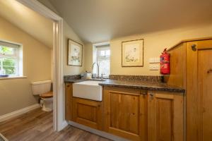 a bathroom with a sink and a toilet at York Cottage in Thornham +28 photos